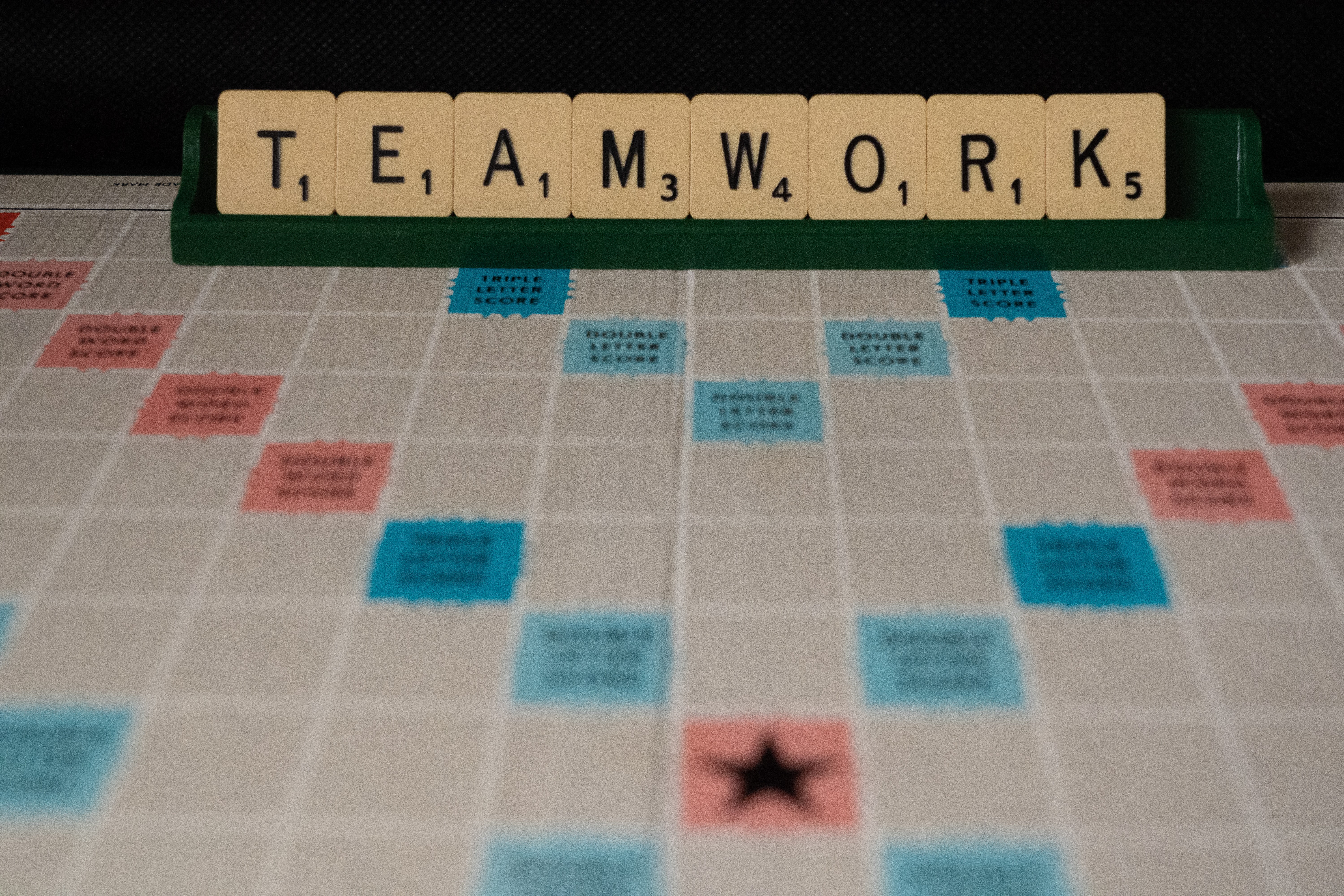 Teamwork displayed on a Scrabble board